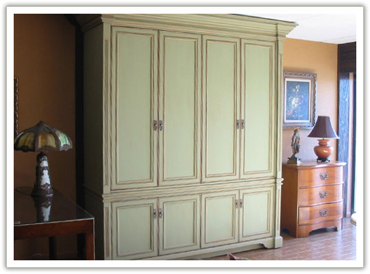 Green with brown and gold glazing entertainment center